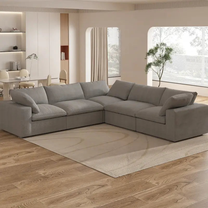 Grand canapé d'angle rembourré de duvet avec pouf pour salon