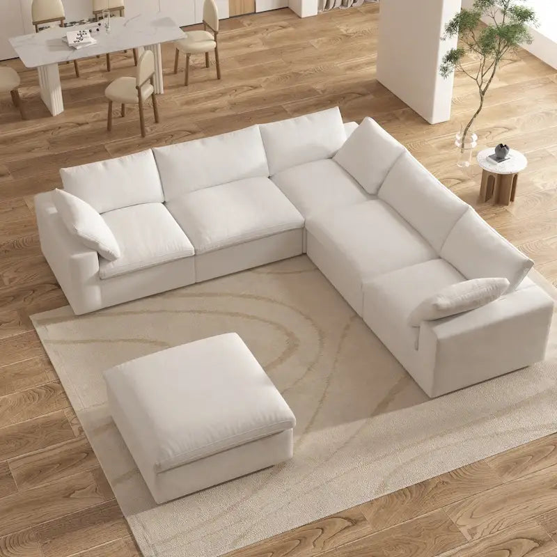 Grand canapé d'angle rembourré de duvet avec pouf pour salon