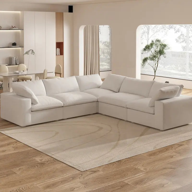 Grand canapé d'angle rembourré de duvet avec pouf pour salon
