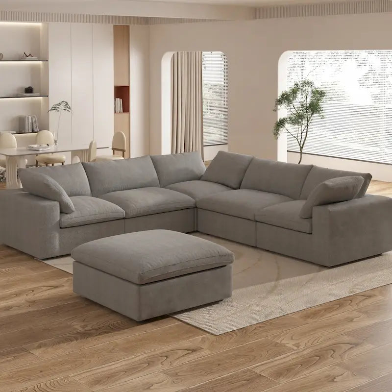 Grand canapé d'angle rembourré de duvet avec pouf pour salon