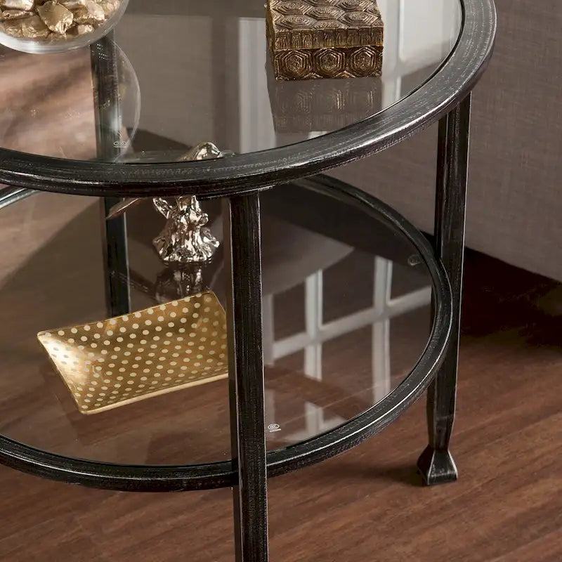 Table d'appoint ronde Glenn de SEI Furniture, en métal noir vieilli, avec plateau en verre et étagère.